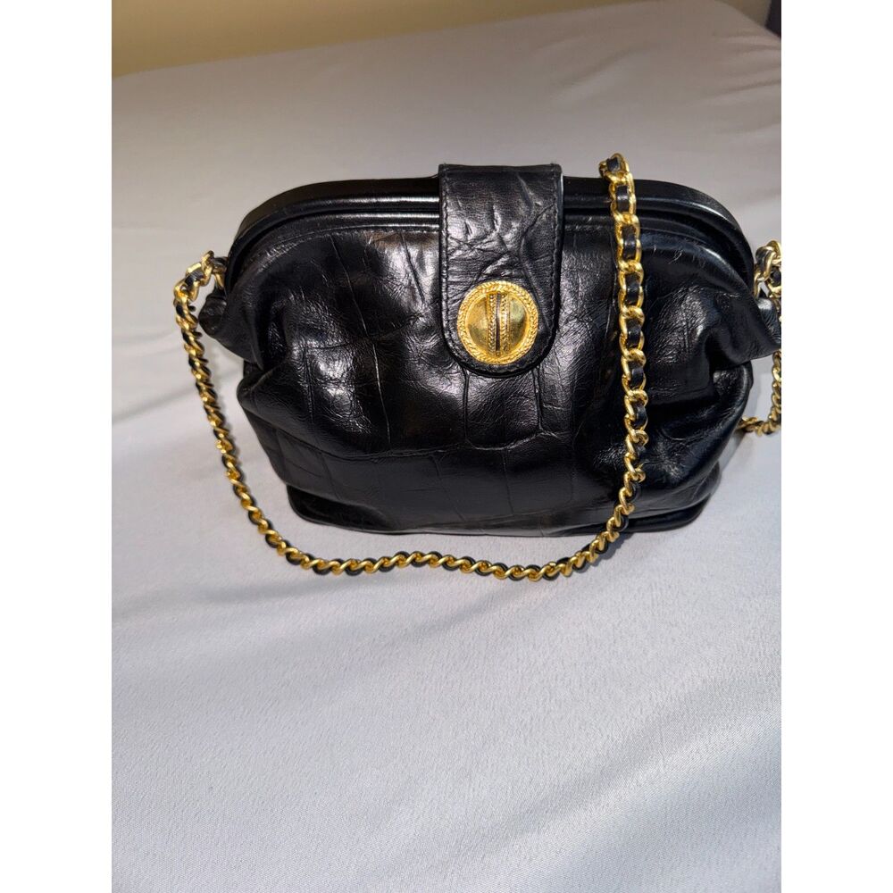 Black  embossed leather small purse with gold chain and clasp.